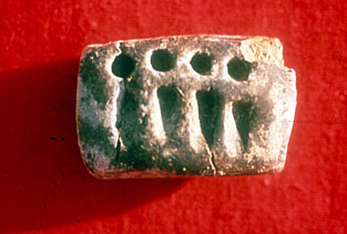 Figure 4. Tablet showing the impression of spheres and cones representing measures of grain, from Godin Tepe, Iran, ca. 3200 B.C. Courtesy Cuyler Young Jr. Royal Ontario Museum, Toronto, Canada. 