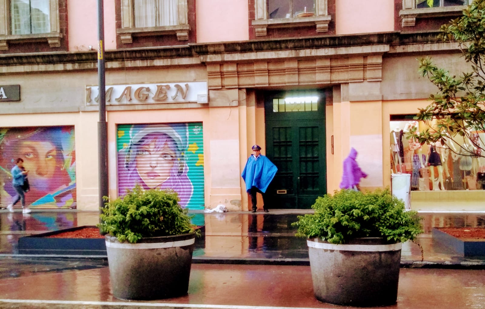 Eldad Levy. "A security guard in a rainy Historic Center of Mexico City."