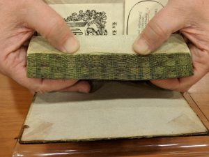 The Ransom Center's copy of Edmond Hoyle's treatise on Whist decorated with a fore-edge painting of playing cards.