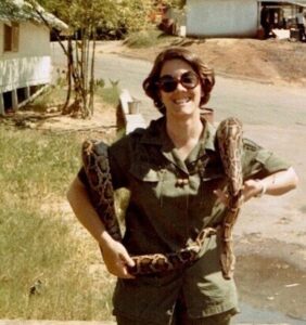 JoAnna on a dare at Marine Base in Vietnam nervously holding a snake