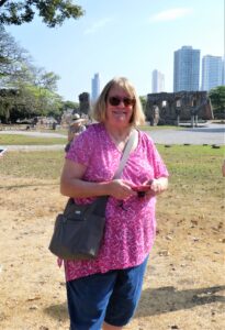 Panama Viejo, Robin Fradenburgh with ruins behind her and modern Panama City in the distance - courtesy of Janet Hicks