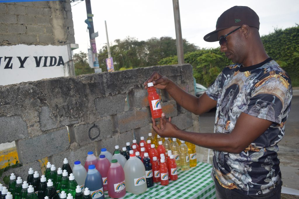 A community members examines a household cleaning product manufactured by Mujeres Unidas. 