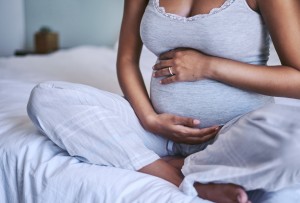 A pregnant woman holding her baby bump