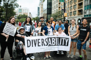 Group of people posing with banner that says Diversability