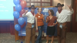Workday program team members get their picture taken with Texas Cowboys