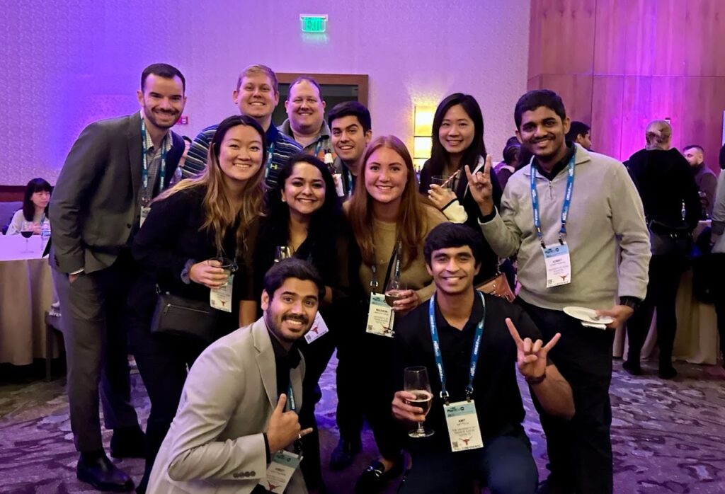 Group photo at AAPS 2022 in Boston, some group members are giving hook 'em horns hand sign