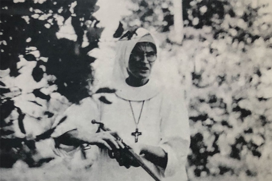 historic photo of nun holding a rifle