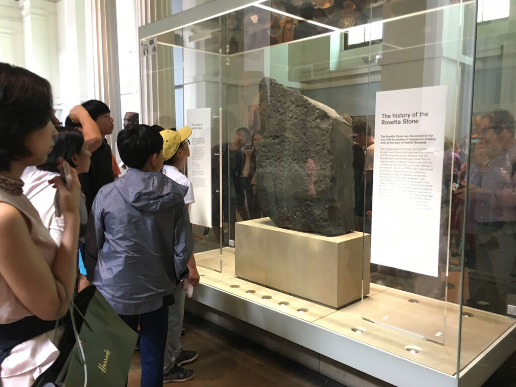 people standing in front of Rosetta Stone