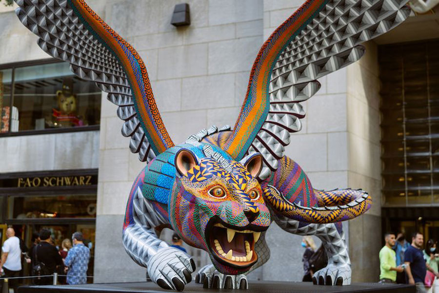 sculpture of winged tiger painted with brightly colored pattern