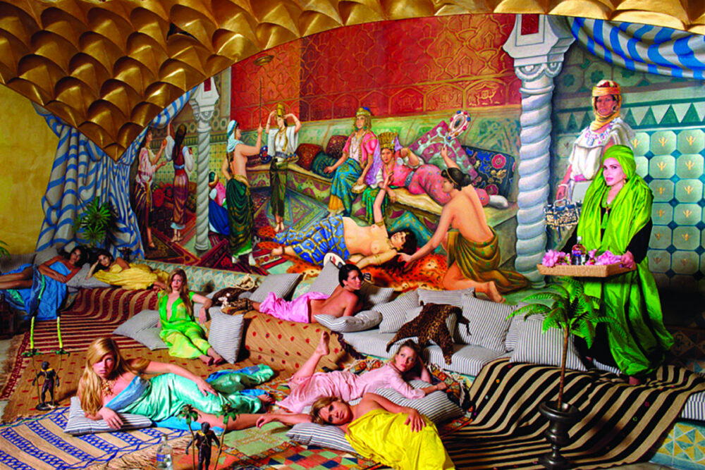 women lounging in colored room with murals on wall