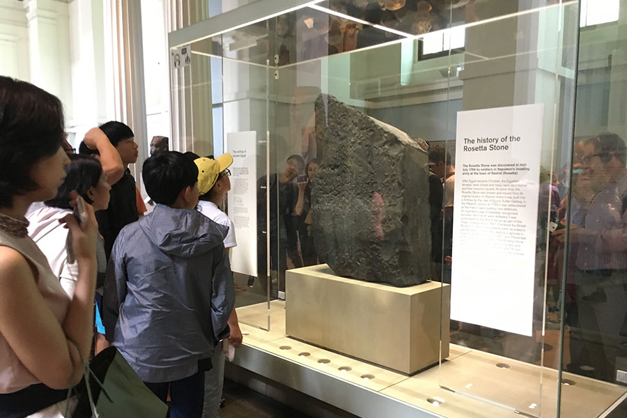 people standing in front of Rosetta Stone