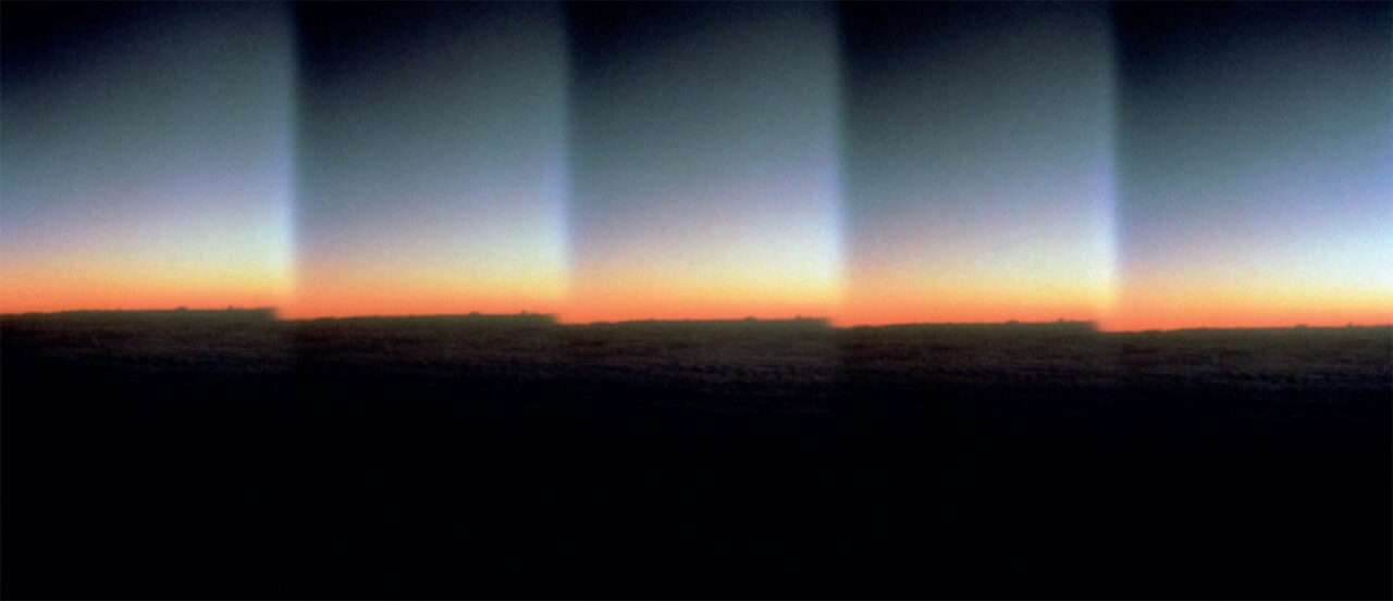 digitally manipulated image showing landscape at dusk repeating horizontally in frame