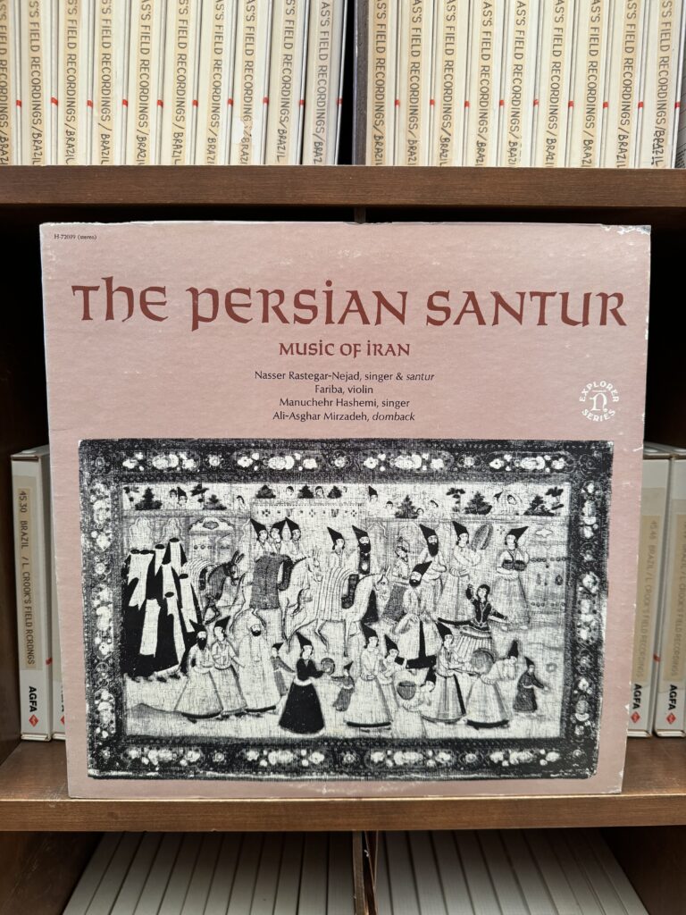 Figure 1: The photo of the art cover of the vinyl “The Persian Santoor”, with a group of musicians on the cover, and tapes in the background.