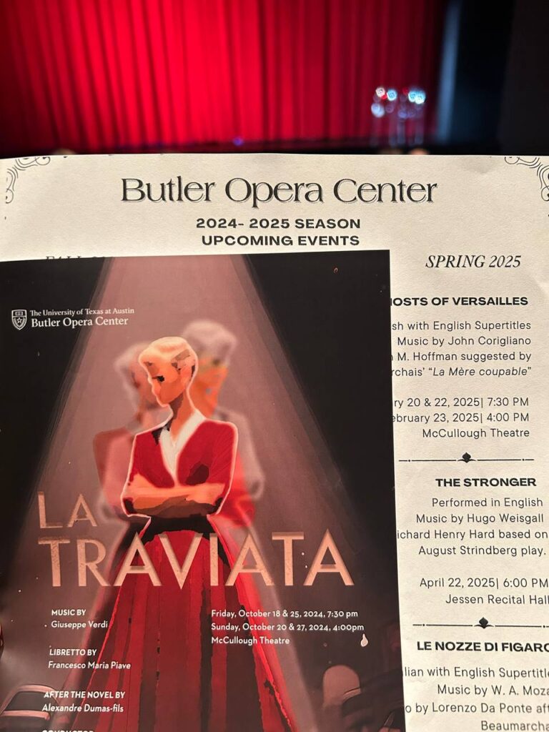 A printed program for the Butler Opera Center’s production of La Traviata, set against the red curtain backdrop of the McCullough Theatre.