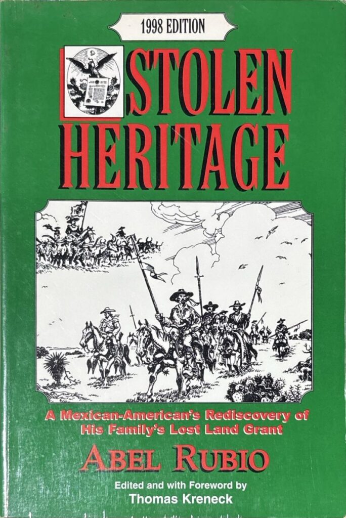 Book cover of Stolen Heritage: A Mexican-American's Rediscovery of His Family's Lost Land Grant. The cover is in green, with the book's title and author's name in red. In the center, there's an illustration in black and white of men on horseback, wearing hats and armed with spears, set against a desert landscape. 