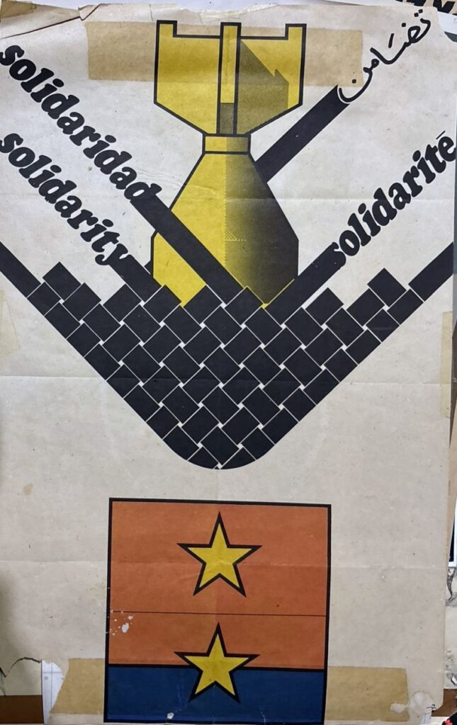 Poster by Cuban artist Olivio Martinez, featuring the word "solidarity" in English, Spanish, French, and Arabic weaved together to stop an incoming bomb.