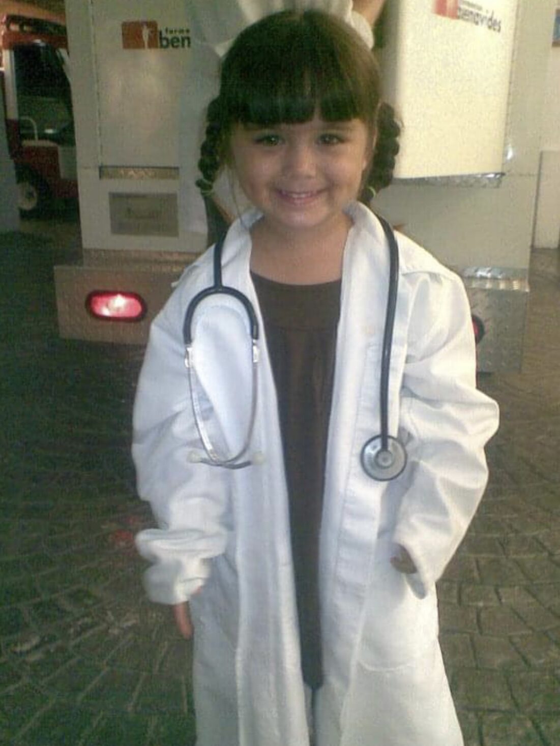 Little girl with braids wearing a doctor outfit