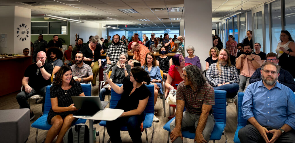 Photo of all staff meeting in UTA Commons.