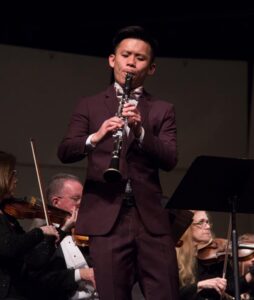 Bruce Luo playing clarinet on stage