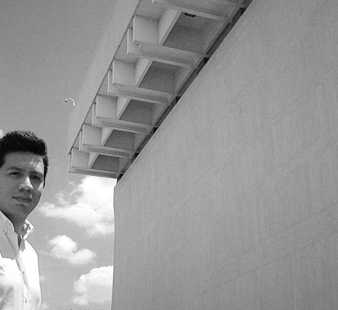 Cristóbal Jácome-Moreno standing before UT LBJ building