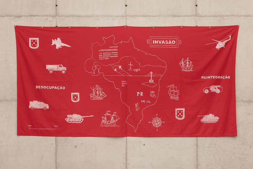 red cotton banner with various visual references to military equipment