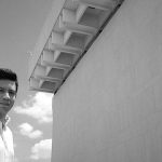 Cristóbal Jácome-Moreno standing before UT LBJ building