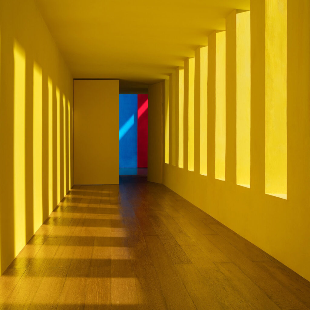 Residential house designed by Luis Barragan, hallway with yellow light