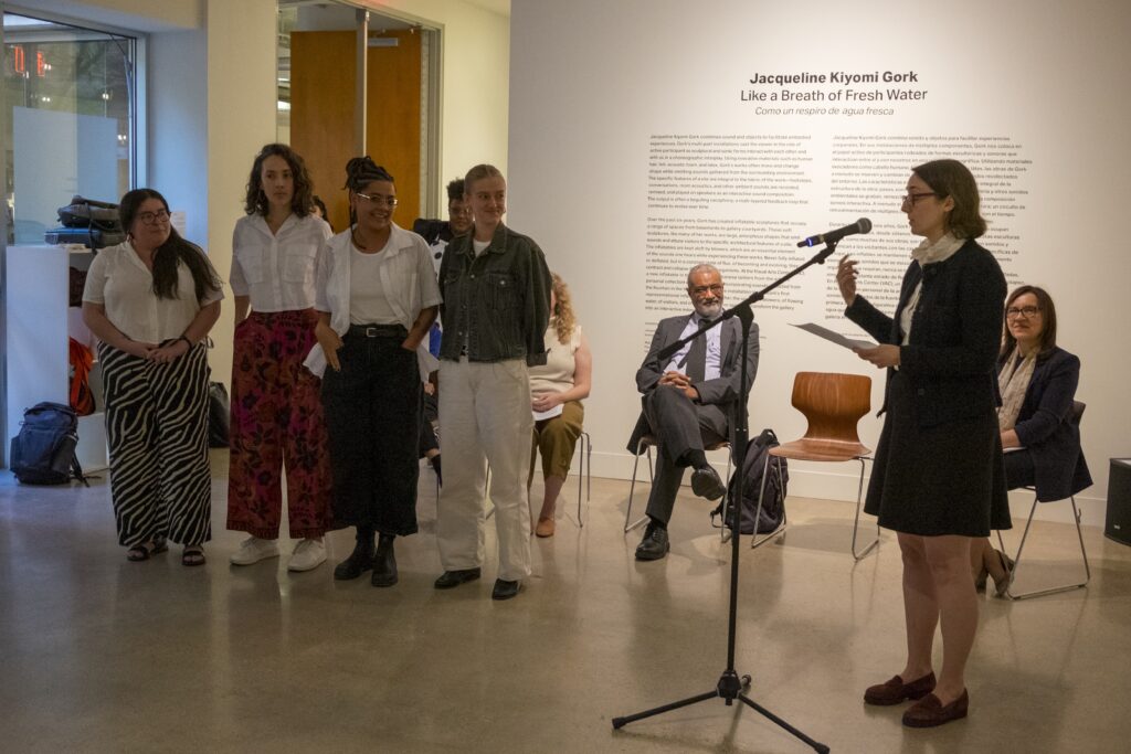 Adele Nelson congratulates the student contributing authors to the Social Fabric catalog at the book launch