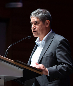 Noel Clemens speaking at podium