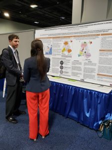 Picture of Paulina Urbanowicz-Pollock with her CM2 poster with Lisa Loftus-Otway and Stephanie Levine, "Identifying Organizational Changes to Facilitate Metropolitan Planning Organization Mega-Region Planning"