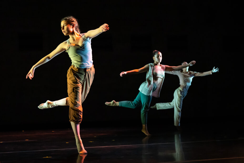 3 students dancing on stage