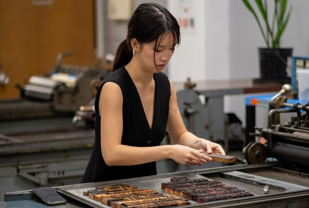 Student preparing to create artwork using letter press