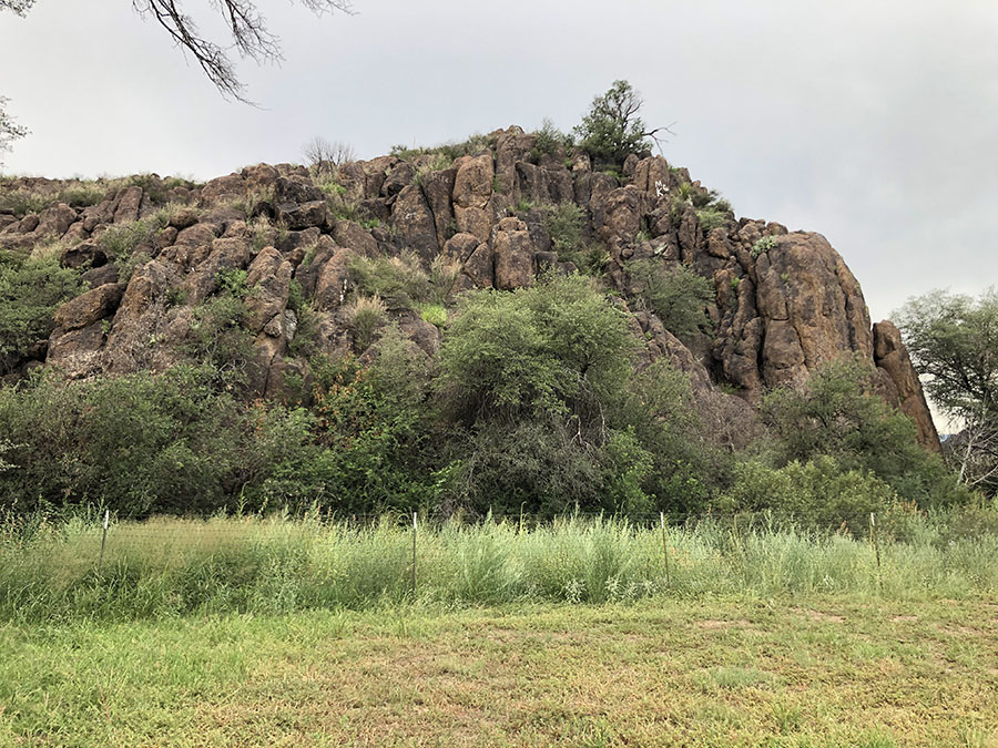 West Texas mountain top, looking like stacked rows of red coins in a soft grassy field