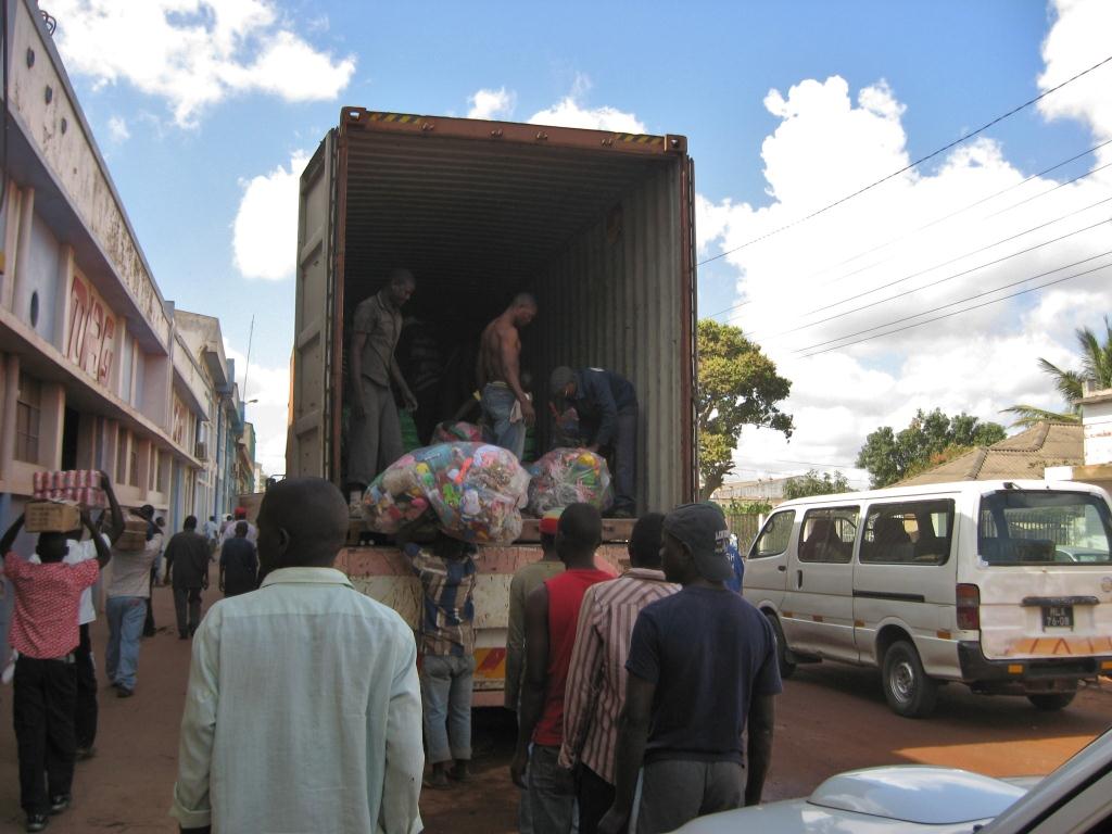 Workers unloading used toys and clothes
