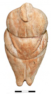 Carved pregnant figure in stone