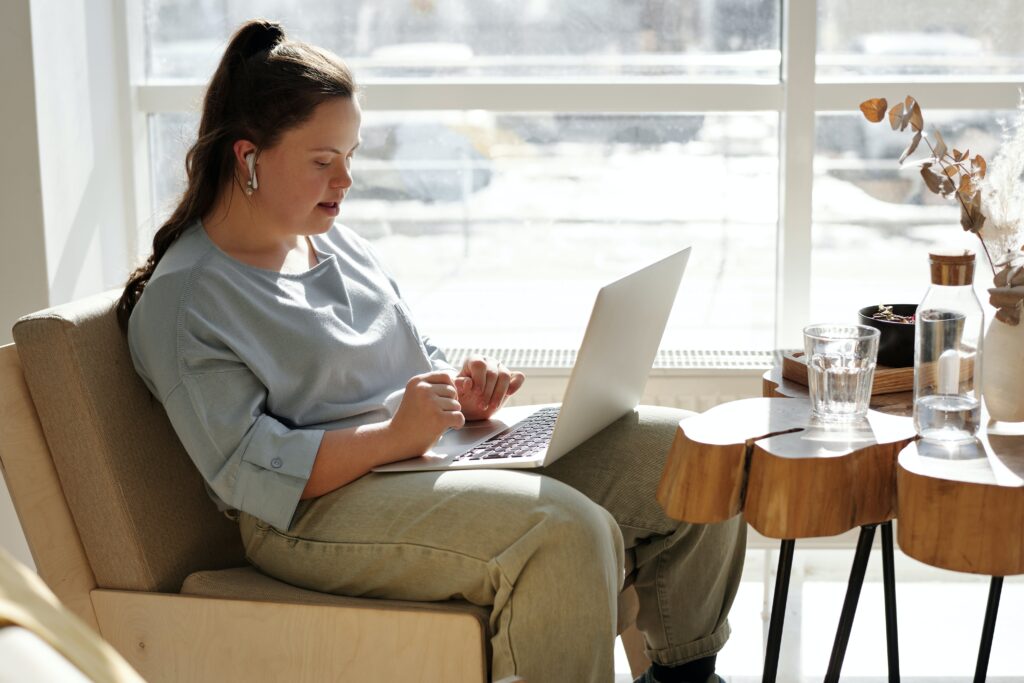 Young woman with intellectual / developmental disabilities on laptop.
