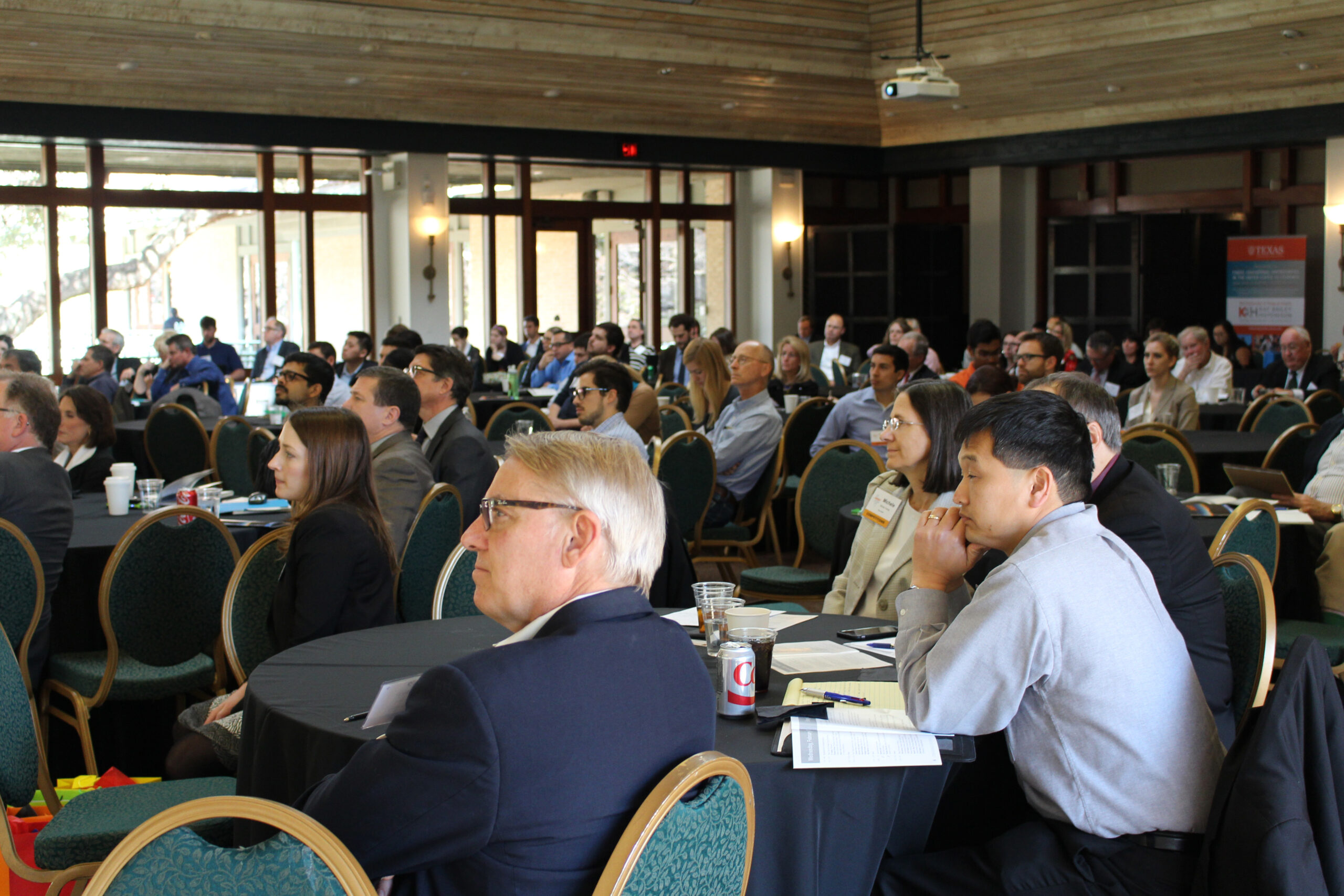A full audience listens to a speaker