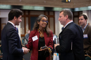 Riffat speaking with Etienne and another person