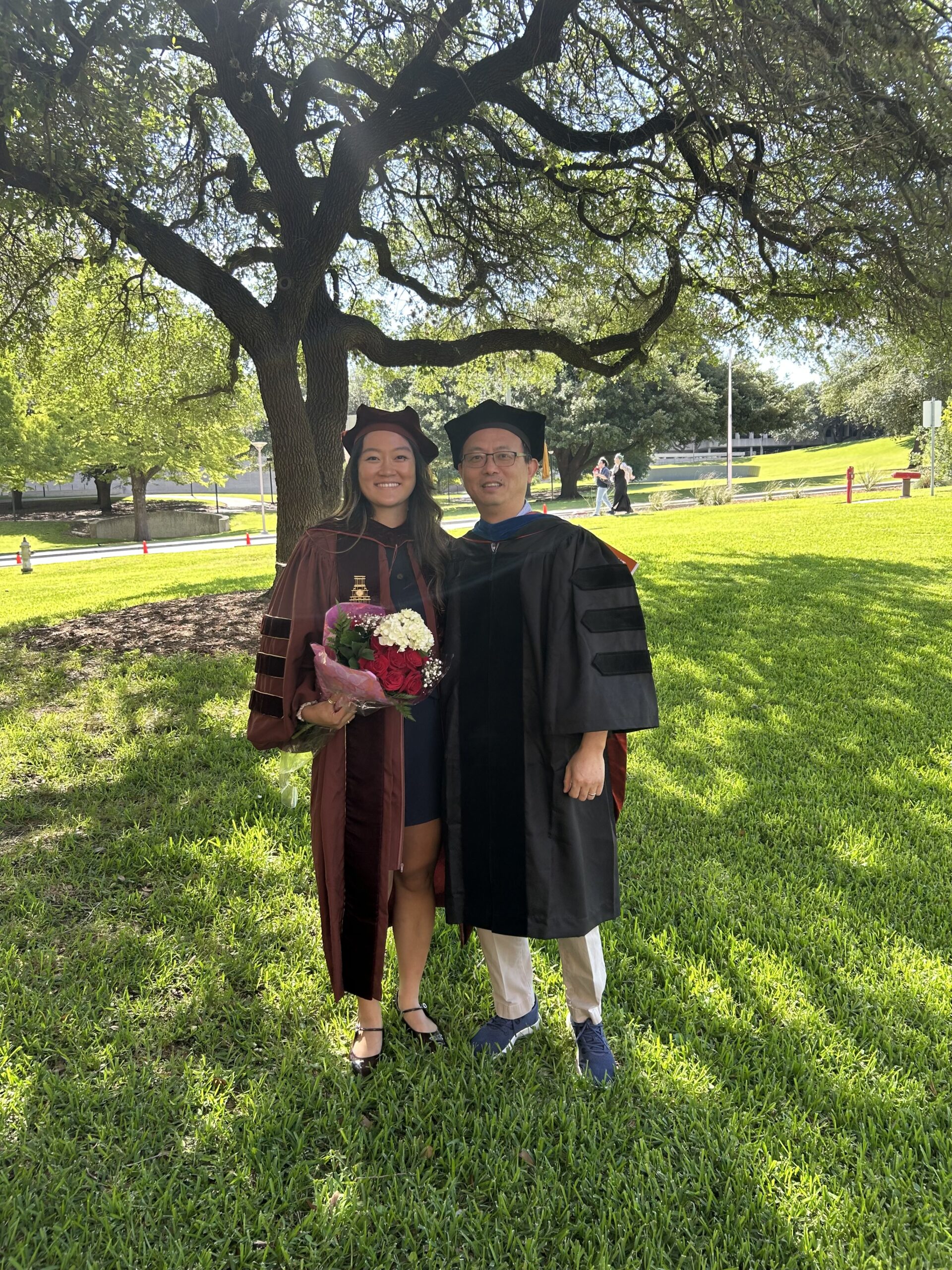 Picture of Angela Ren with Feng Zhang after her graduation.