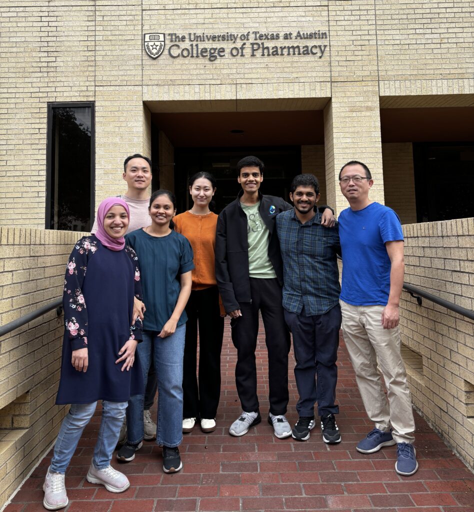 Feng Zhang group members standing together outside of College of Pharmacy Building.