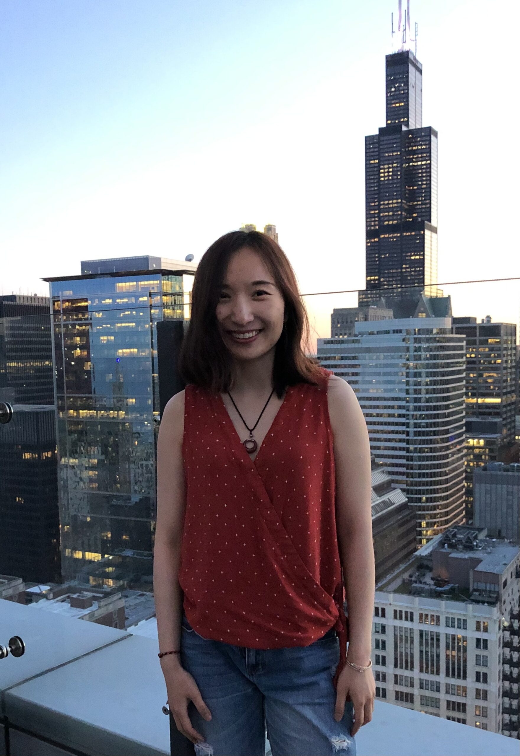 Yuting Pan smiling on a city rooftop