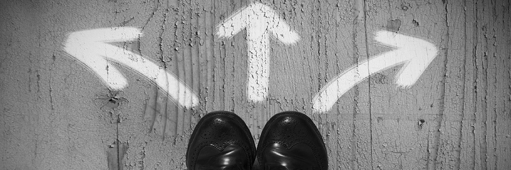 A pair of black shoes facing three white arrows pointing in different directions, indicating three possible paths to change. Text reads, "Healthy change starts here." Underneath that, a "Request a Training" button that links to HBRT's Training page.