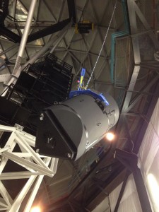 The lift of the Wide Field Corrector begins.  The Corrector has its side plates mounted so no optics are visible.