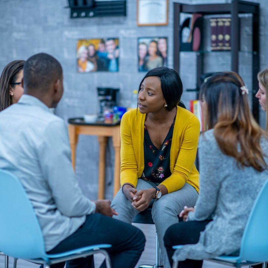 woman talking to a group of people
