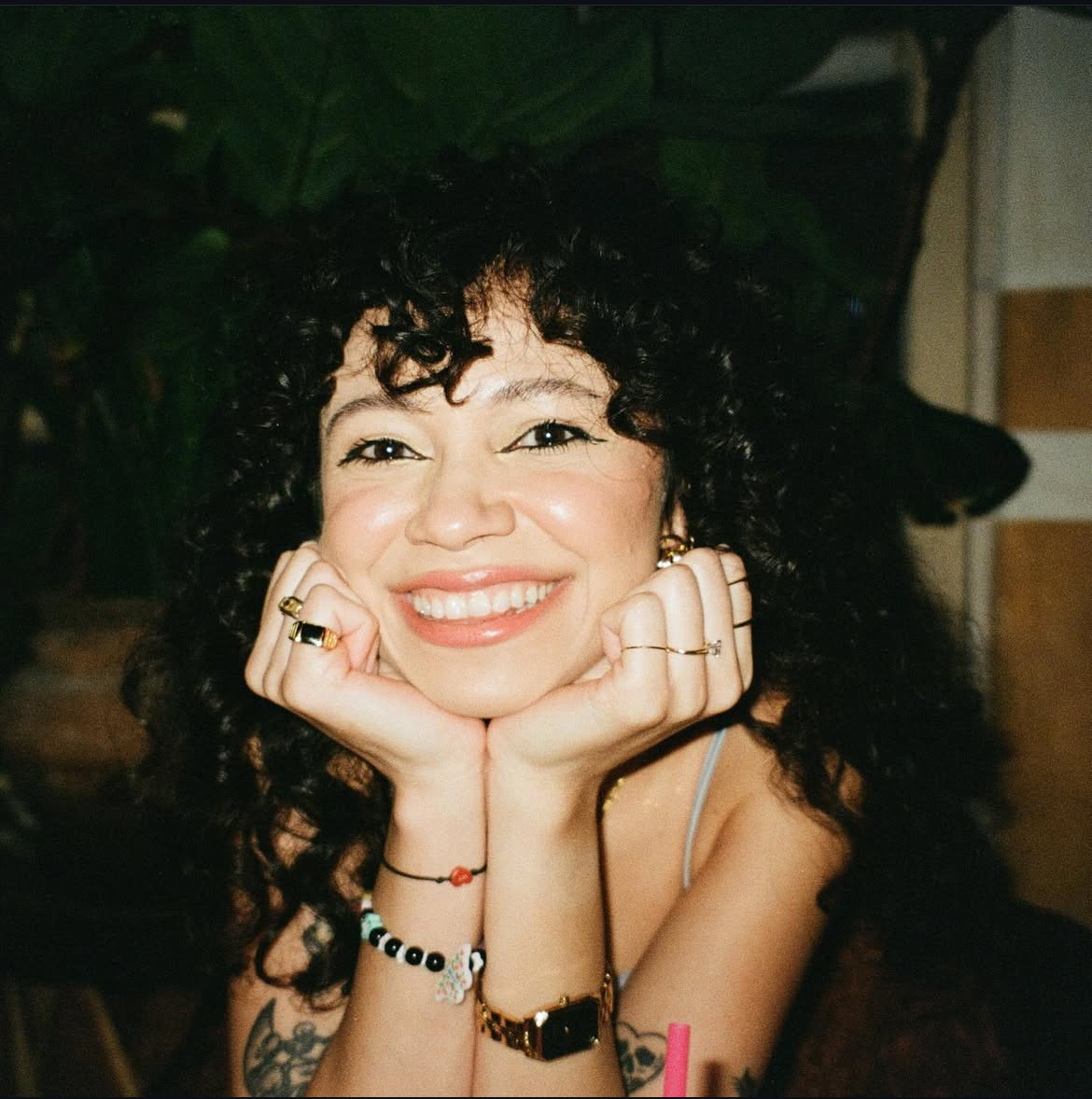 Woman with curly brown hair smiling