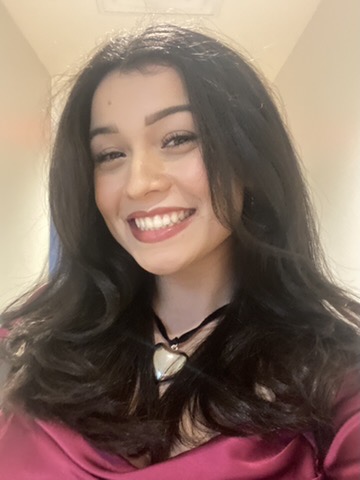 Woman with brown curled hair smiling