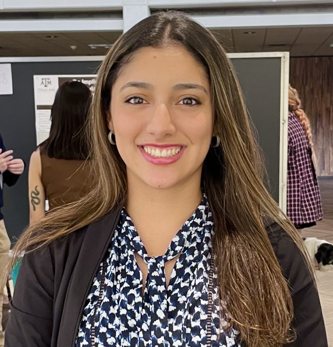 Woman with long brown hair smiling