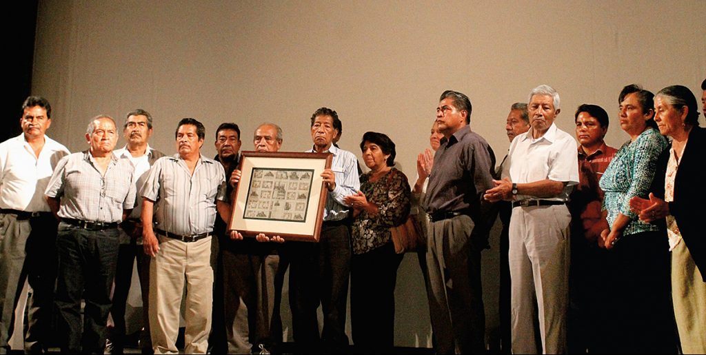 Mayordomos and fiscales (church-based community leaders) of San Pedro Cholula and San Andrés Cholula receive a reproduction of the 1581 map held at the Benson Latin American Collection on October 5, 2015, at the Teatro de la Ciudad de Puebla.