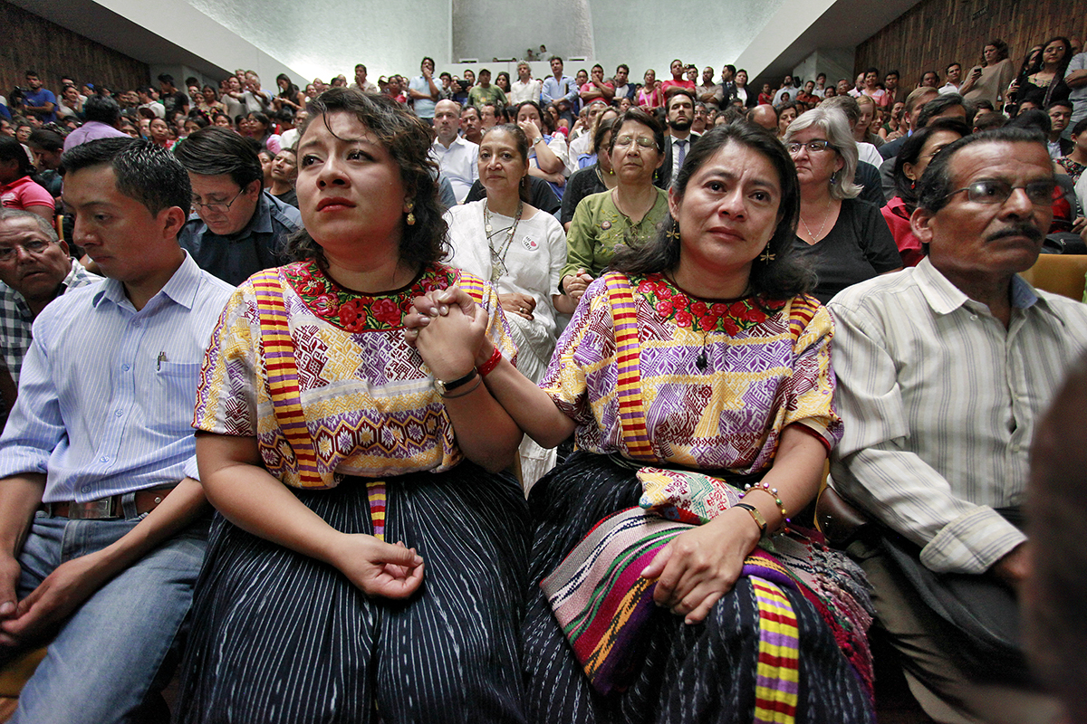 Together with hundreds of human rights activists and representatives from foreign institutions, the author (center-right) holds hands with her daughter as theguilty verdict is read in the Ríos Montt trial. Supreme Court of Justice, Guatemala, May 10, 2013. © Daniel Hernández-Salazar, 2013.