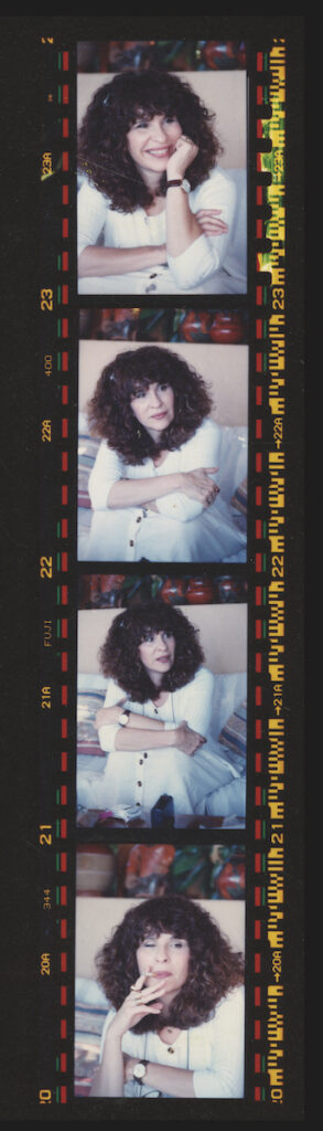 A vertical strip of four photos of Belli as a young woman, with voluminous dark hair, wearing white, each time in a different pose. In one, she smokes a cigarette.